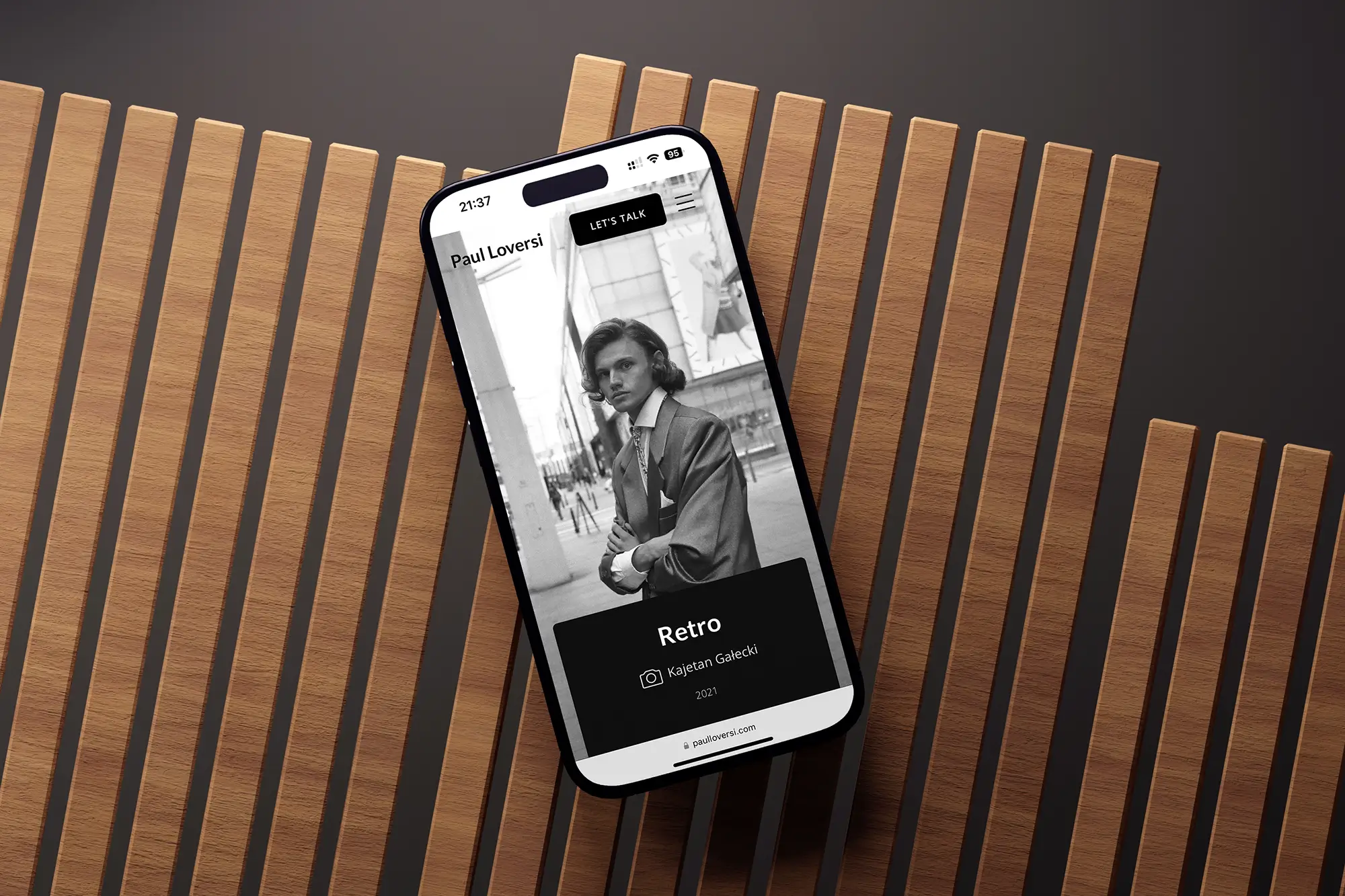iPhone mockup displaying Paul Loversi mobile portfolio design with vertical scrolling photo gallery layout.