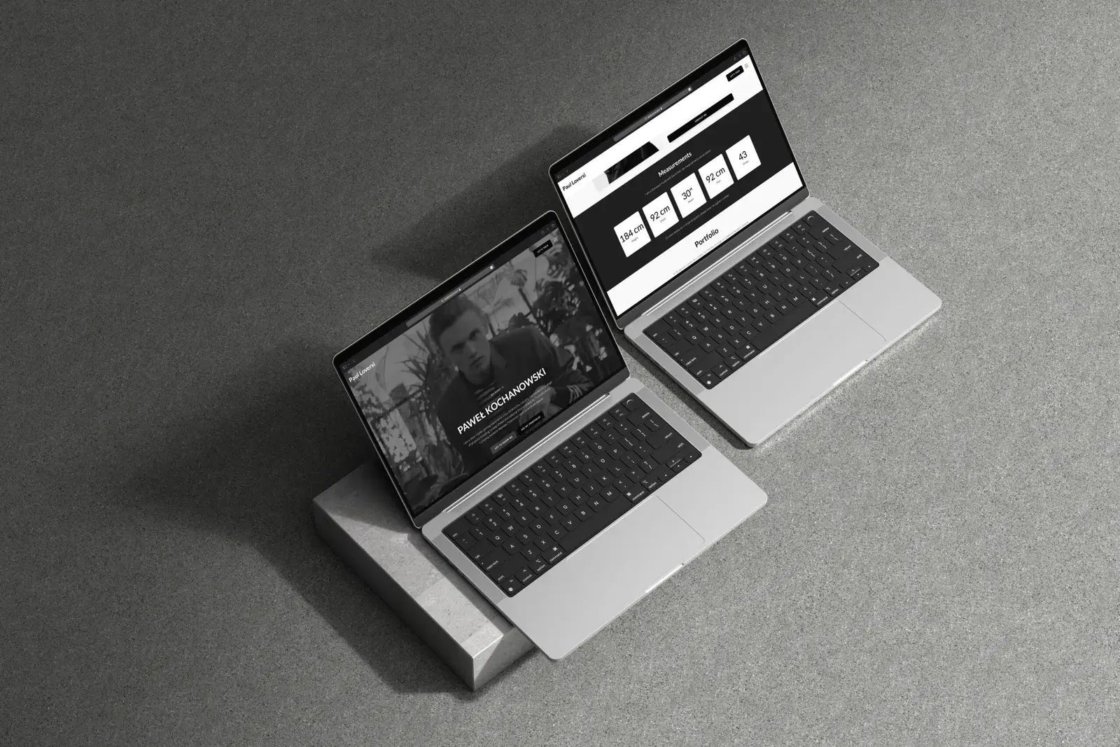 Two laptops displaying Paul Loversi portfolio website showing homepage and measurements section design.